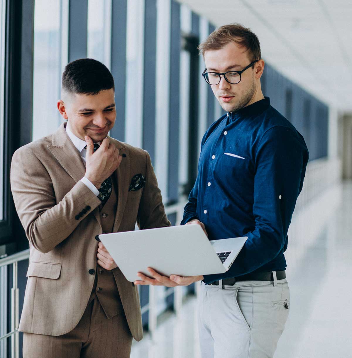 Two business professionals reviewing information together on a laptop